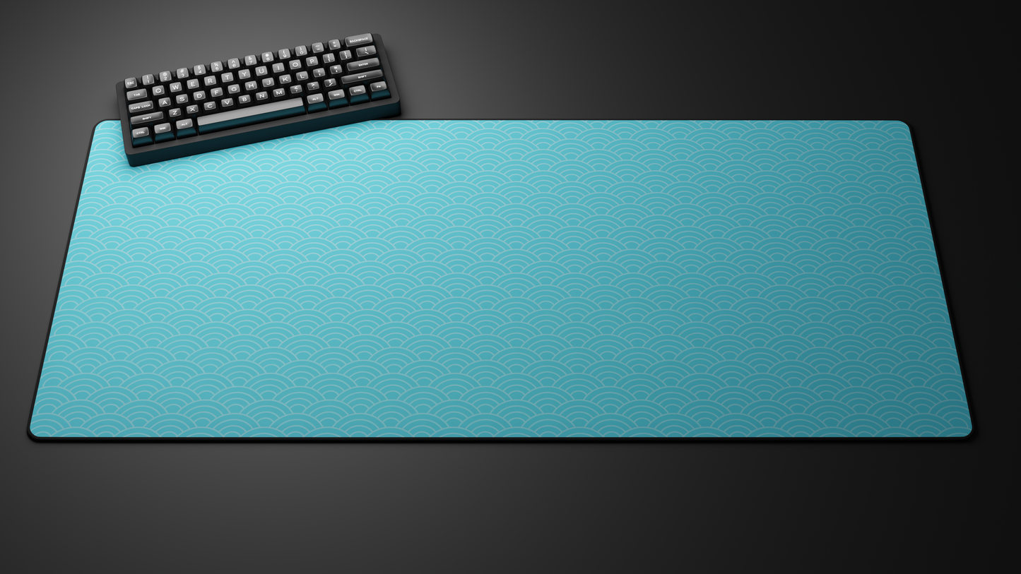 Computer keyboard on a large blue desk mat